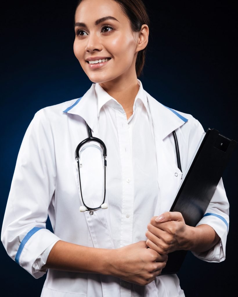 Portrait of young cheerful doctor with stethoscope holding folder and looking aside isolated over black